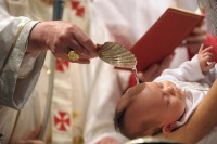 Pope Benedict XVI baptise a baby during a mass in Sistine Chapel at the Vatican