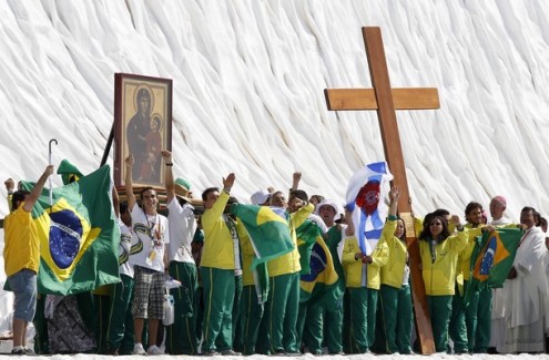 Brazilian pilgrims lift the World Youth Day cross at the Cuatro Vientos aerodrome in Madrid