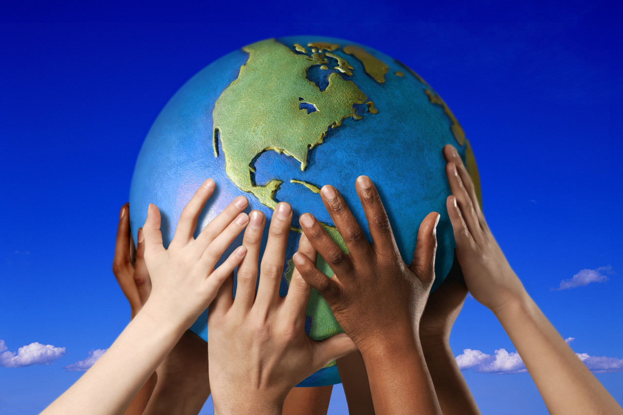 Hands on a globe --- Image by © Royalty-Free/Corbis