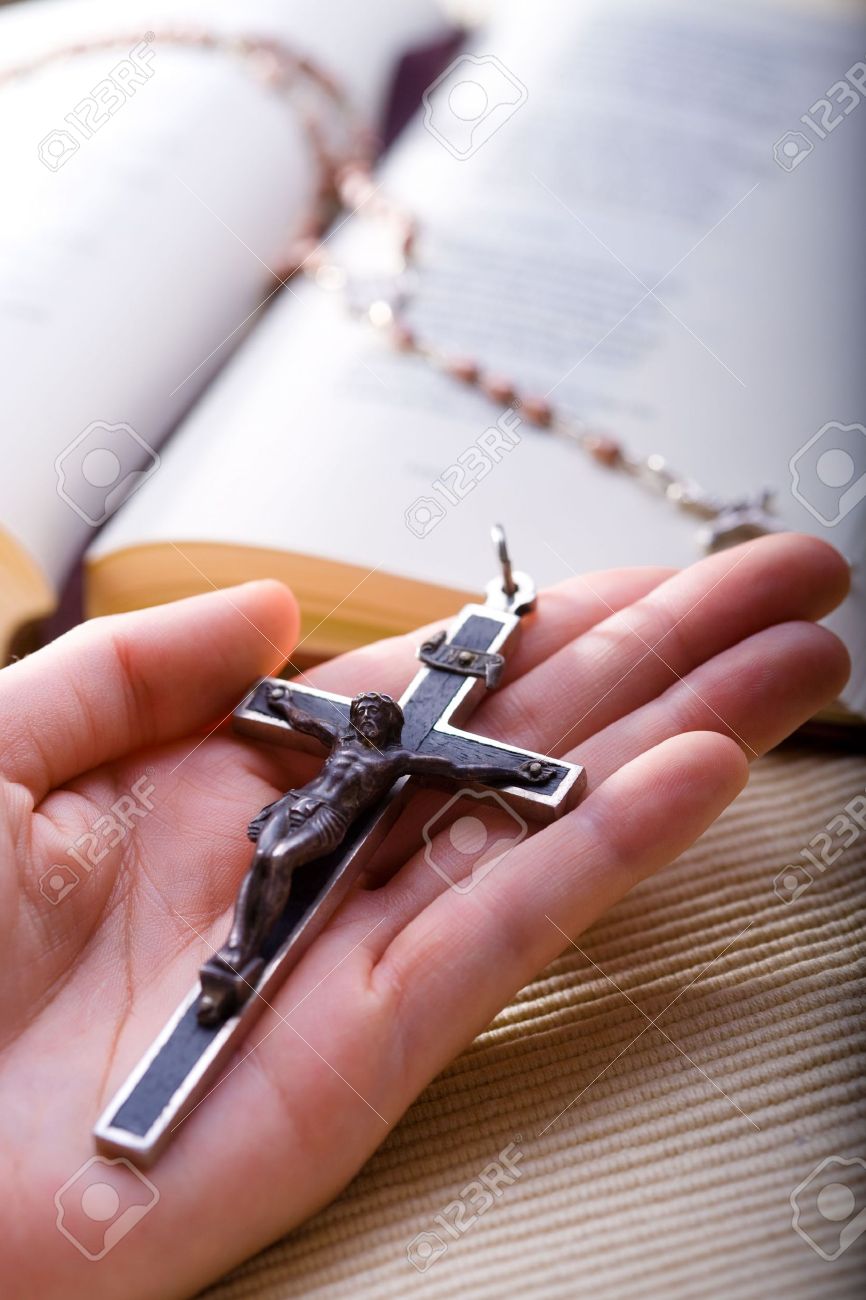 1850996-Christian-believer-holding-old-cross-in-hand--Stock-Photo